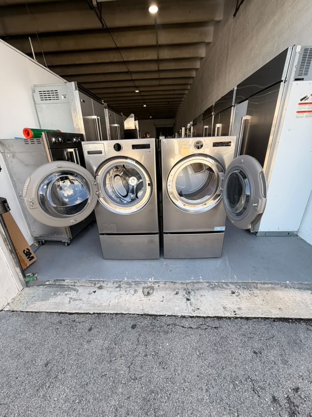 Actual lg 27-inch washer and dryer set photographed in Oakland Park — actual set · washer and dryer doors open