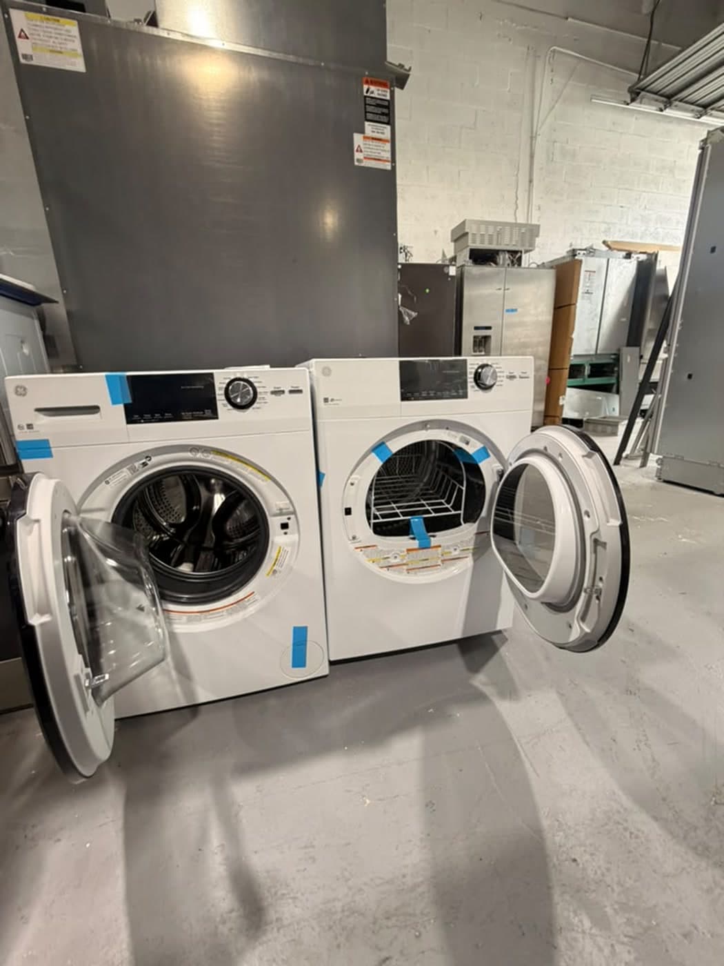 Actual ge 24-inch washer and dryer set photographed in Oakland Park — actual set · washer and dryer doors open