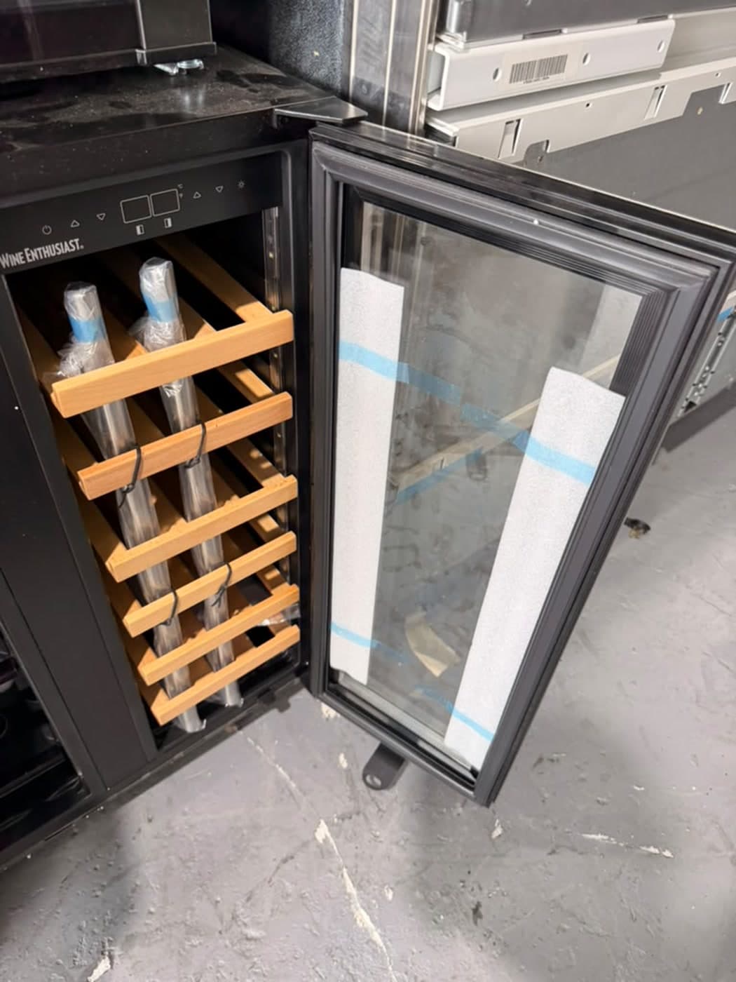 Actual wine enthusiast 24-inch wine & beverage center photographed in Oakland Park — actual unit · wine-side interior with wood racks