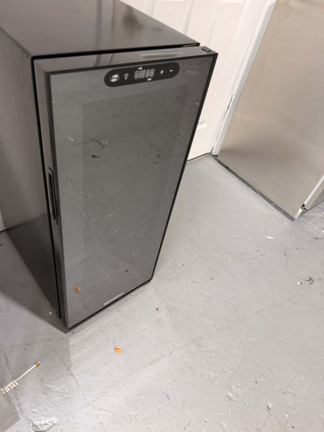 Actual wine enthusiast 18-bottle dual zone wine cooler photographed in Oakland Park — actual unit · alternate closed angle