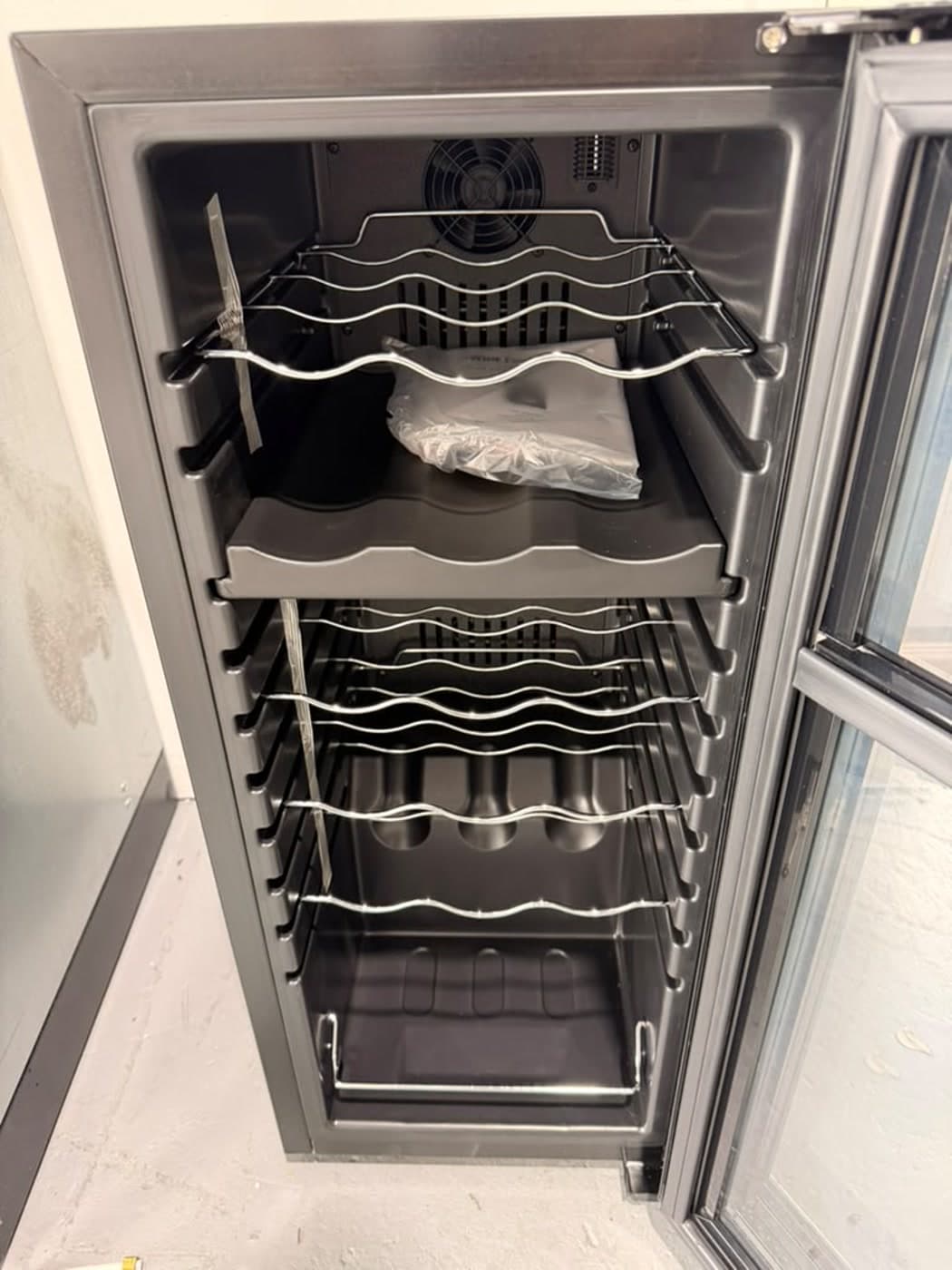 Actual wine enthusiast 18-bottle dual zone wine cooler photographed in Oakland Park — actual unit · wine racks