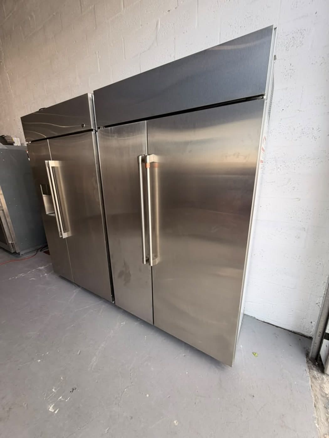 Actual café 48-inch side-by-side refrigerator photographed in Oakland Park — actual unit · closed side angle